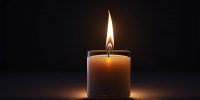 Beautiful candle burning in a dark room professionally and aesthetically photographed, wallpaper, background.